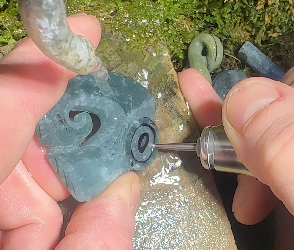 Joe using a diamond rotary tool on Guatemalan Jadeite with intricate inlay preparation.