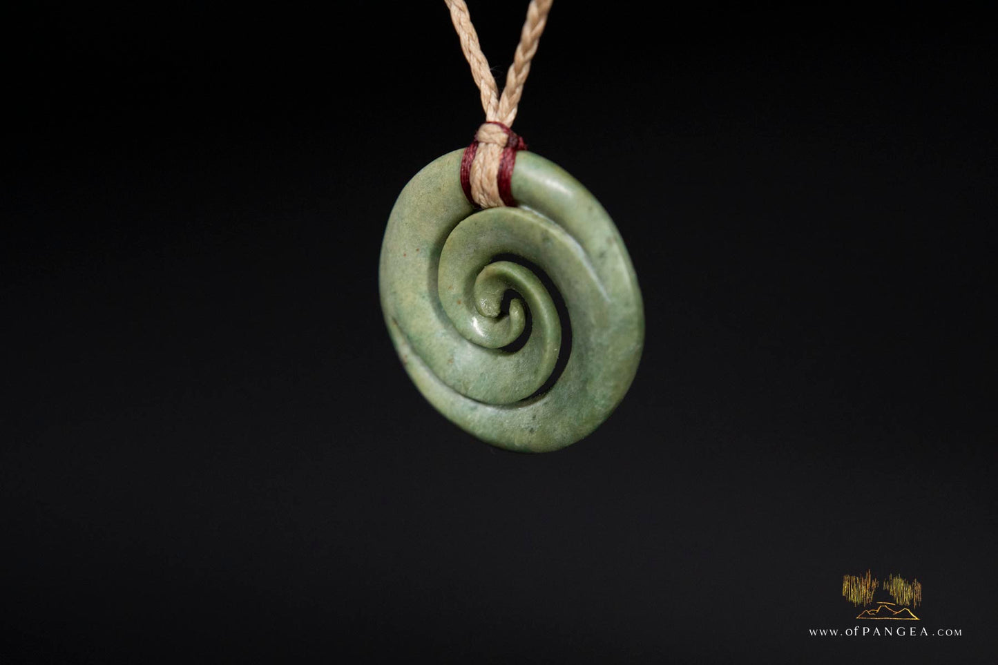 Double koru carved from nephrite jade kawakawa pounamu greenstone