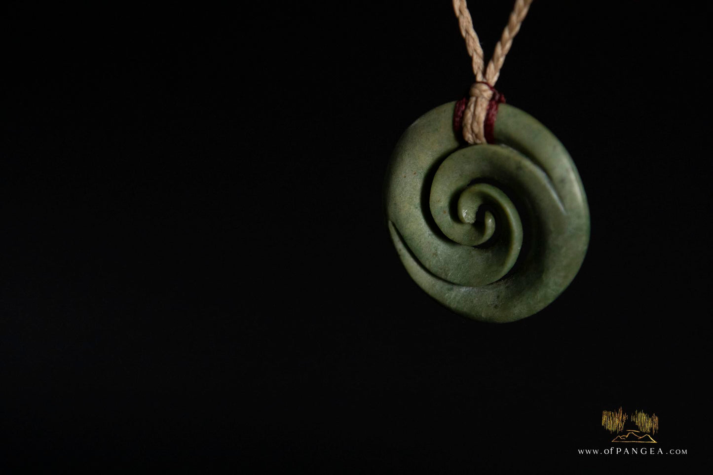 Double koru carved from nephrite jade kawakawa pounamu greenstone