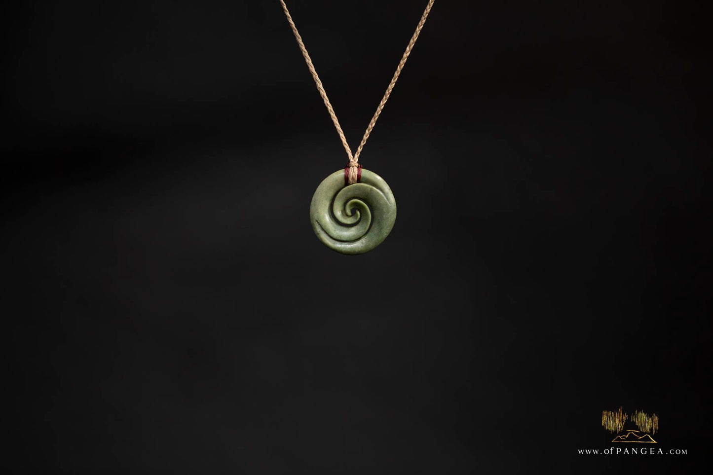 Double koru carved from nephrite jade kawakawa pounamu greenstone