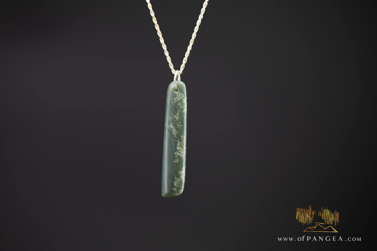 Flat lay of cherry blossom Wyoming nephrite jade toki pendant on sterling silver chain — JF997
