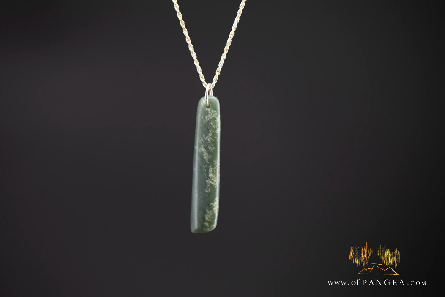 Flat lay of cherry blossom Wyoming nephrite jade toki pendant on sterling silver chain — JF997
